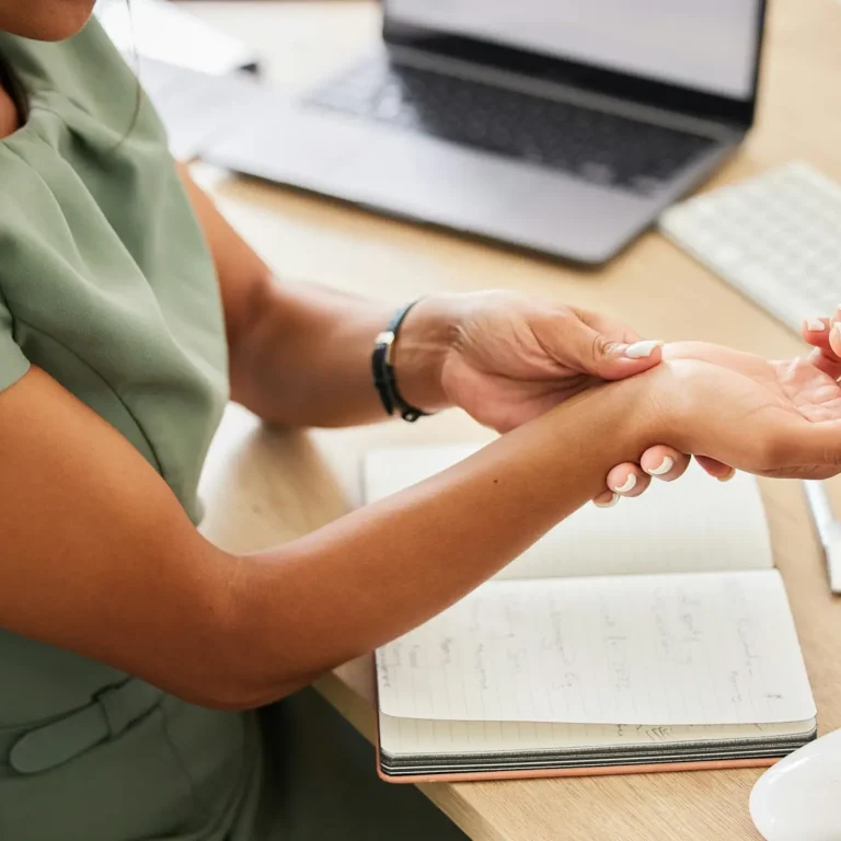 Business woman, wrist injury and pain from osteoporosis, orthopedic joint and working in office. Fe